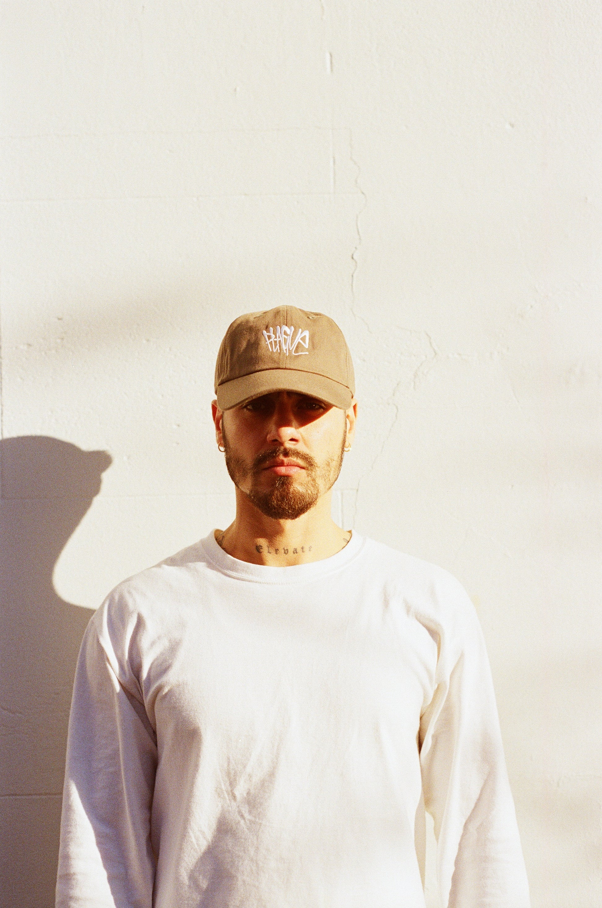 Model wearing PLAGUE FIELD CAP with white background